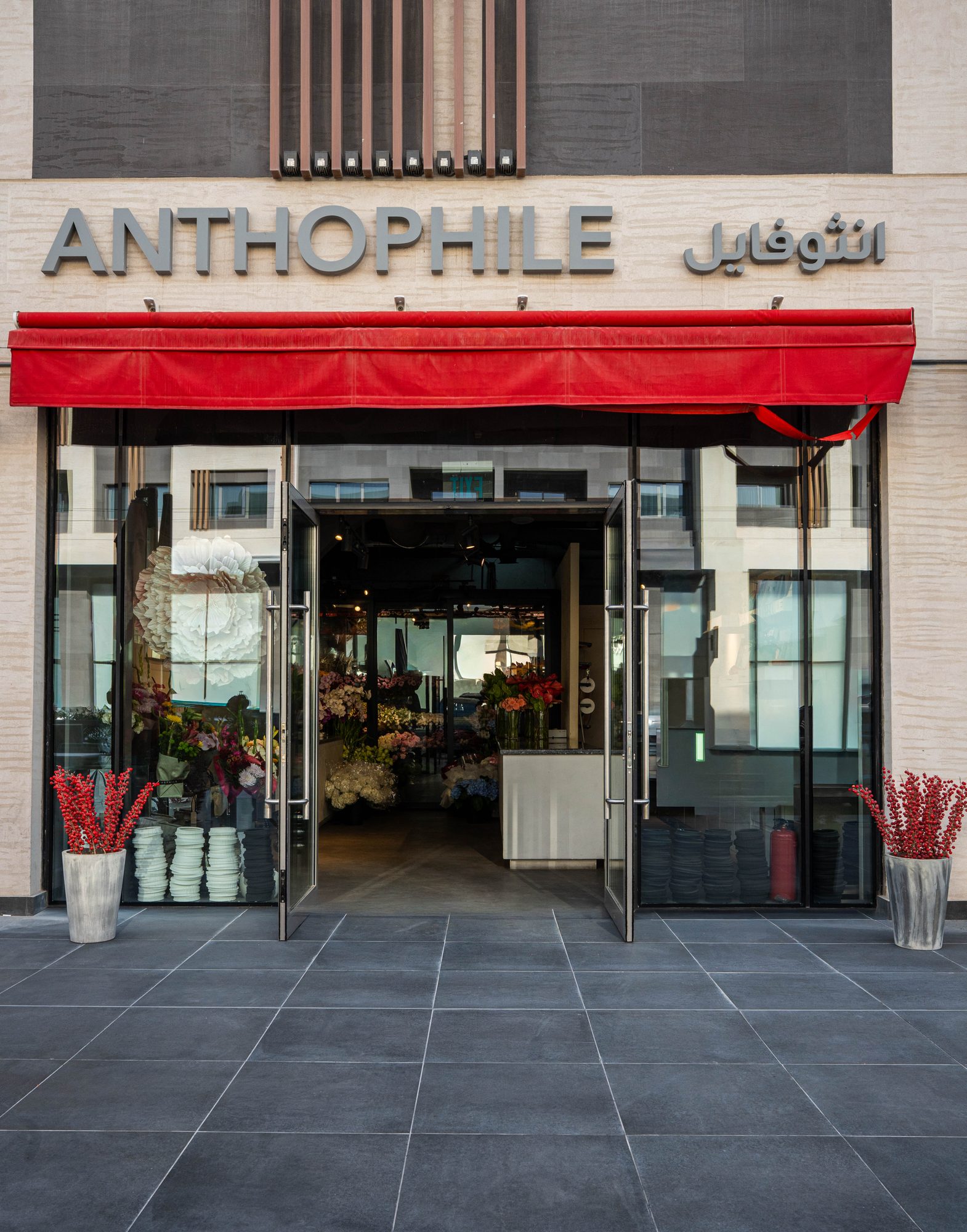 Anthophile storefront with a red awning